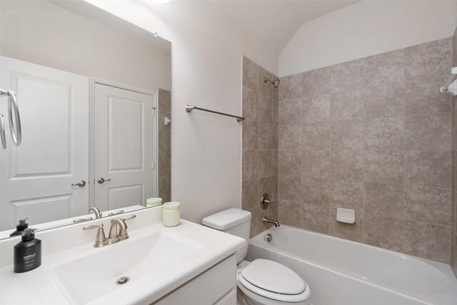 full bath featuring lofted ceiling, bathing tub / shower combination, vanity, and toilet