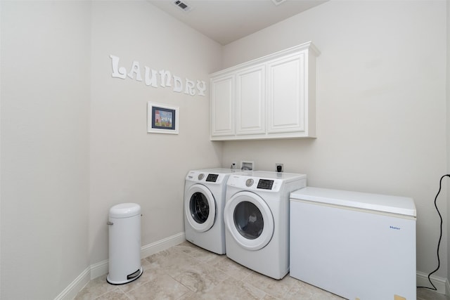 washroom featuring cabinet space, independent washer and dryer, visible vents, and baseboards