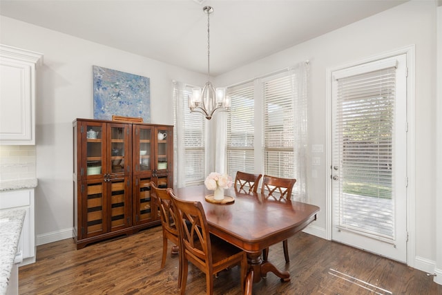 dining area with baseboards, an inviting chandelier, and dark wood-style flooring