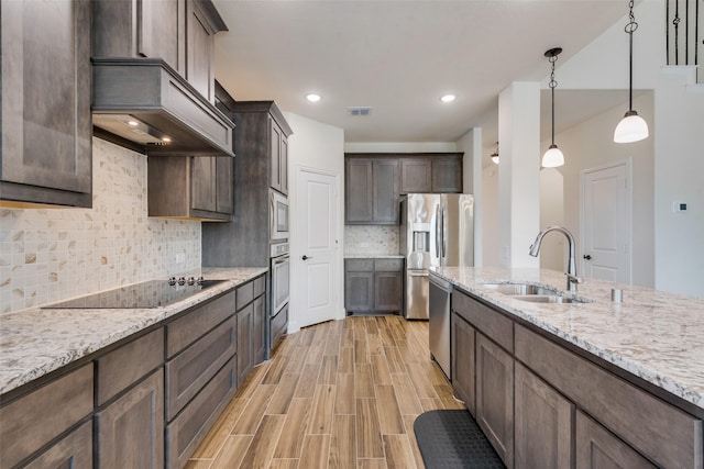 6517 Harwich Dr, Mesquite, TX 75181 - kitchen featuring a sink, appliances with stainless steel finishes, light stone counters, and dark brown cabinetry