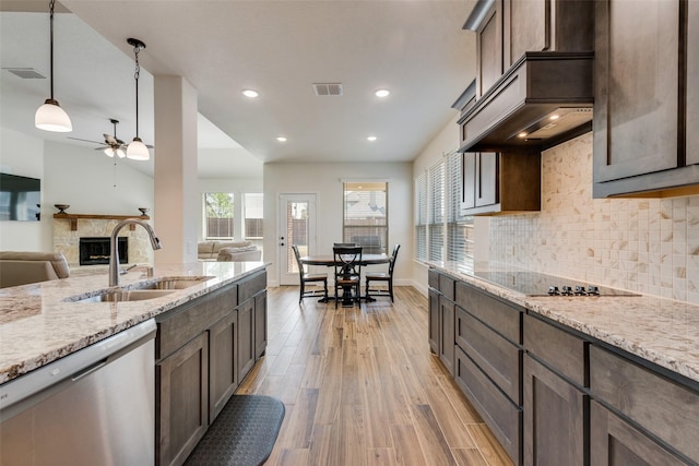 6517 Harwich Dr, Mesquite, TX 75181 - kitchen with visible vents, a sink, ceiling fan, a stone fireplace, and stainless steel dishwasher
