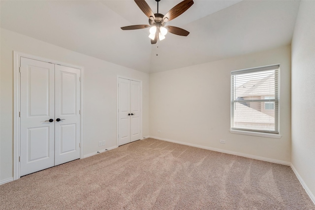 6517 Harwich Dr, Mesquite, TX 75181 - unfurnished bedroom featuring baseboards, carpet flooring, two closets, and vaulted ceiling