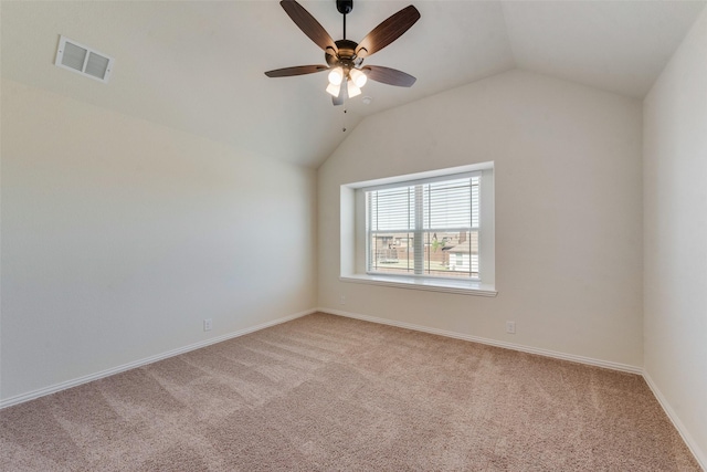6517 Harwich Dr, Mesquite, TX 75181 - spare room featuring light carpet, visible vents, vaulted ceiling, and a ceiling fan