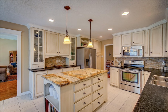 kitchen featuring light tile patterned floors, a center island, open shelves, appliances with stainless steel finishes, and decorative backsplash