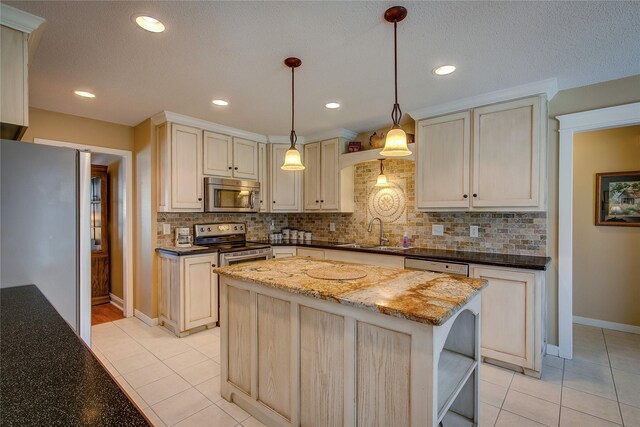 kitchen featuring decorative backsplash, baseboards, a sink, and appliances with stainless steel finishes