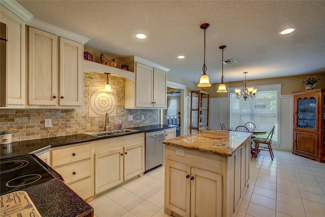 kitchen featuring stainless steel dishwasher, visible vents, a textured ceiling, and a sink