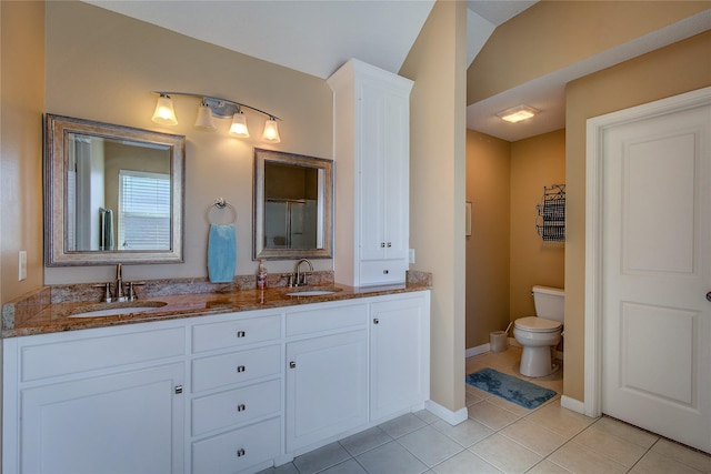full bathroom featuring a sink, tile patterned floors, double vanity, and toilet