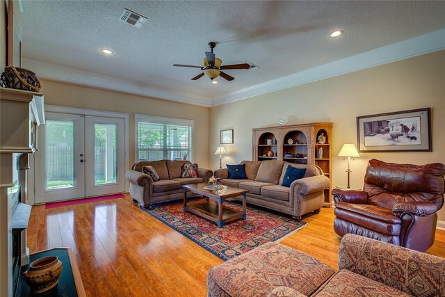 800 Austin Acre, Sulphur Springs, TX 75482 - living room with french doors, a textured ceiling, light wood finished floors, ceiling fan, and ornamental molding