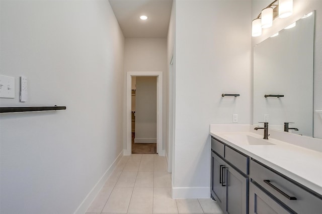bathroom featuring tile patterned floors, baseboards, and vanity