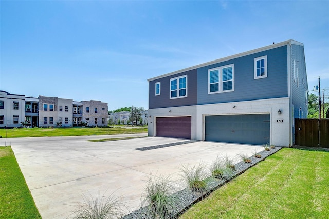 view of front of property with a garage, a front yard, and driveway