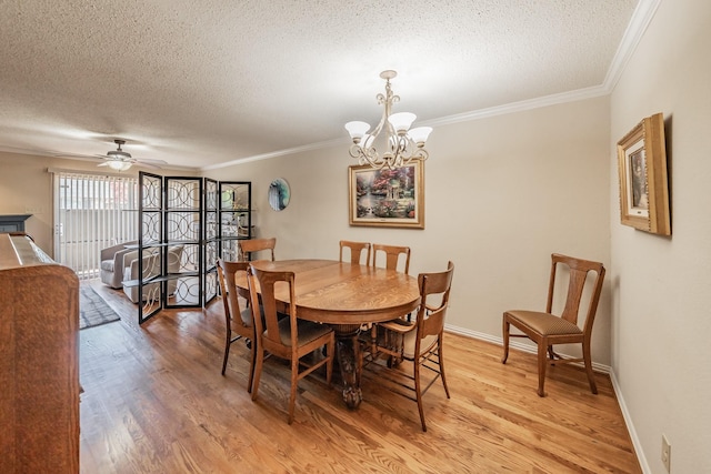 dining area featuring light wood-style flooring, a textured ceiling, and crown molding