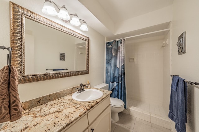 bathroom featuring tile patterned flooring, vanity, a stall shower, and toilet
