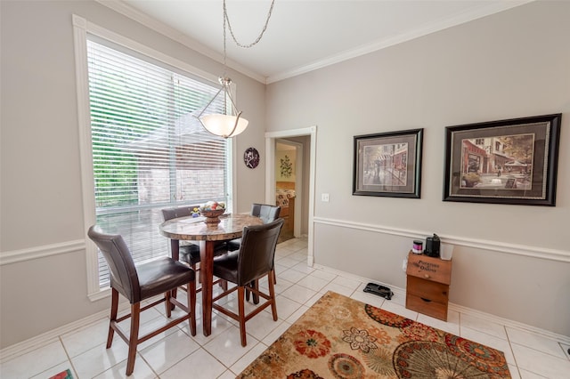 dining area with light tile patterned flooring, baseboards, and ornamental molding