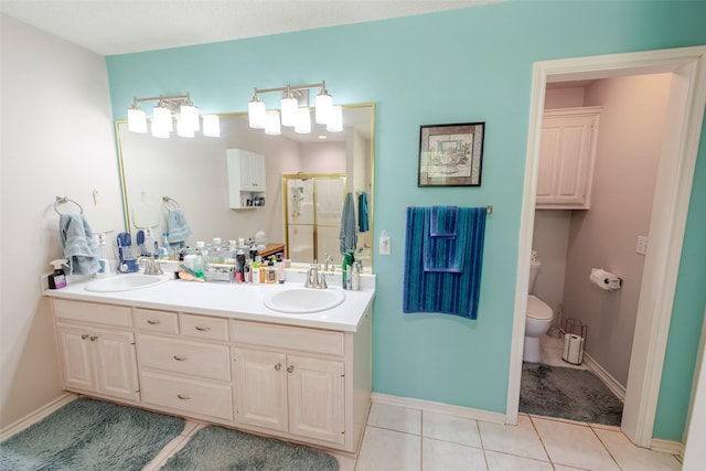 full bath with a sink, toilet, double vanity, and a stall shower