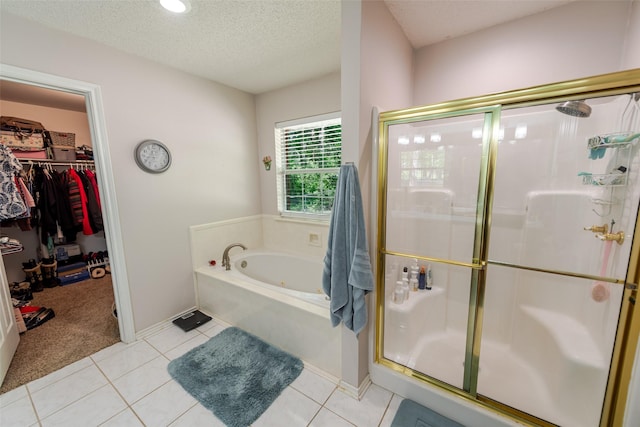 full bath featuring a bath, a walk in closet, and a stall shower