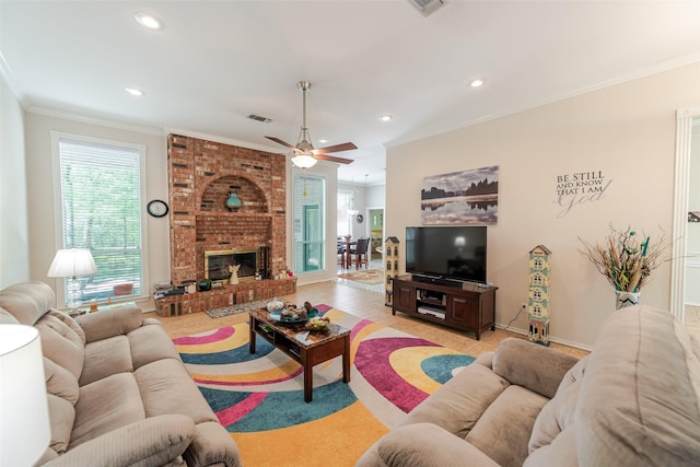 living room with a healthy amount of sunlight, ceiling fan, ornamental molding, and recessed lighting