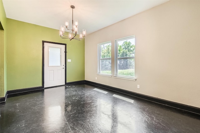 2001 Ryan Ct, Weatherford, TX 76085 - spare room featuring concrete floors, a notable chandelier, and baseboards
