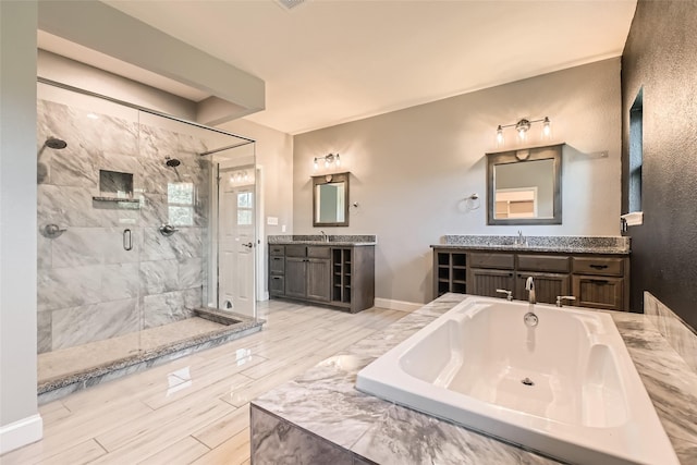 2001 Ryan Ct, Weatherford, TX 76085 - bathroom featuring a sink, two vanities, a stall shower, and a garden tub