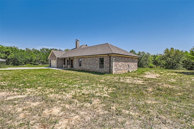 2001 Ryan Ct, Weatherford, TX 76085 - view of side of property featuring concrete driveway, a chimney, brick siding, a garage, and a yard