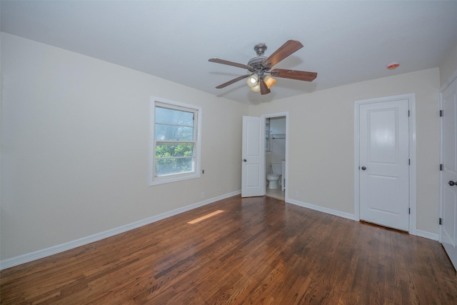unfurnished bedroom featuring dark wood-style flooring, baseboards, and a ceiling fan