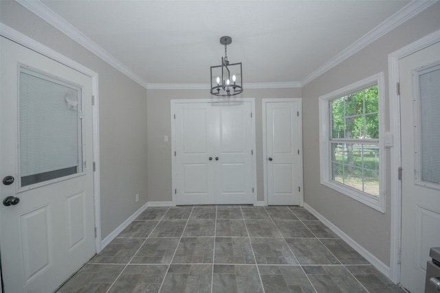 interior space with crown molding, baseboards, and an inviting chandelier