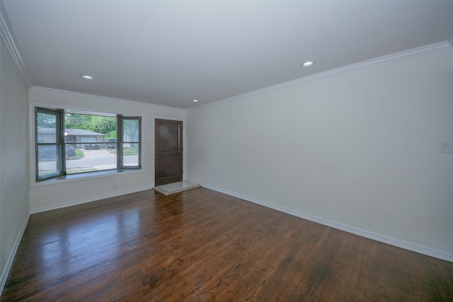 empty room with crown molding, baseboards, dark wood-style floors, and recessed lighting