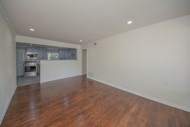 unfurnished living room featuring dark wood-type flooring, baseboards, ornamental molding, and visible vents