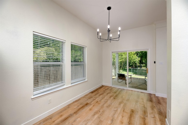 3945 Ringdove Way, Fort Worth, TX 76262 - unfurnished dining area featuring a chandelier, light wood-type flooring, and baseboards