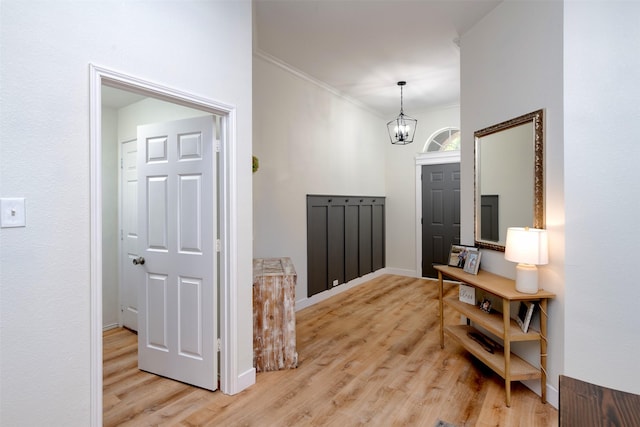 3945 Ringdove Way, Fort Worth, TX 76262 - foyer with a chandelier, crown molding, light wood-style flooring, and baseboards