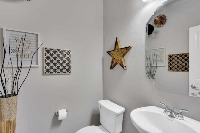 bathroom featuring toilet and a sink