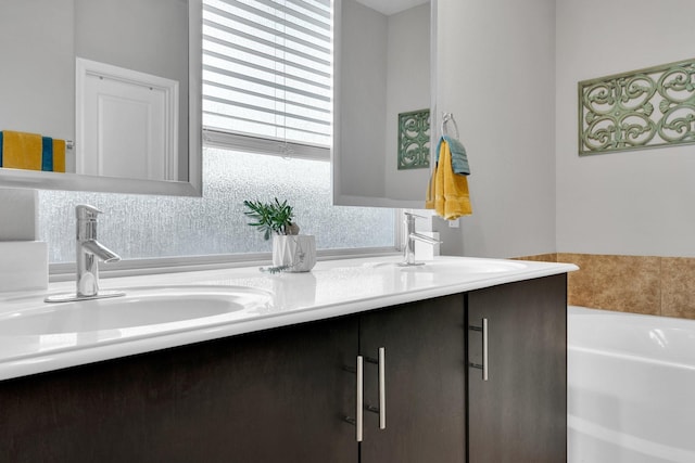 full bathroom featuring a sink, a bath, double vanity, and decorative backsplash