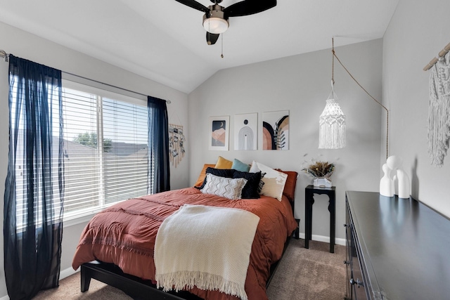 bedroom featuring baseboards, vaulted ceiling, ceiling fan, and light carpet