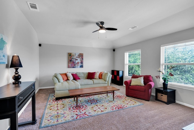 carpeted living room with visible vents, baseboards, and a ceiling fan