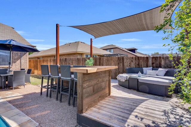 deck featuring a fenced backyard, outdoor lounge area, outdoor dining space, and outdoor dry bar