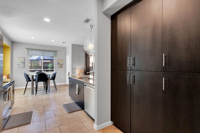 kitchen with dark brown cabinets, visible vents, dishwasher, and a sink