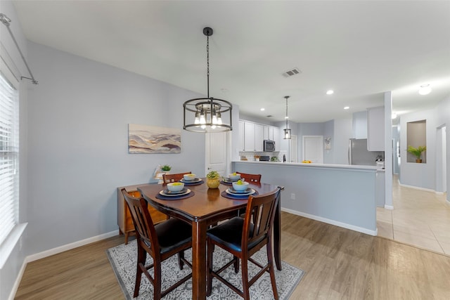 dining room with visible vents, baseboards, a chandelier, recessed lighting, and light wood-style flooring