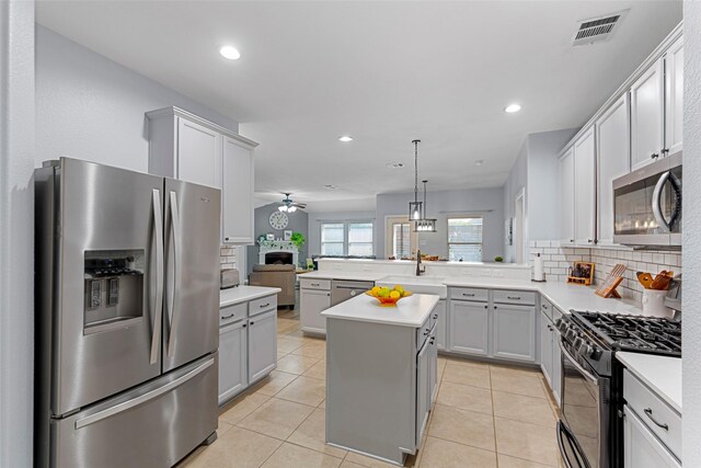 kitchen with tasteful backsplash, visible vents, appliances with stainless steel finishes, a ceiling fan, and gray cabinets