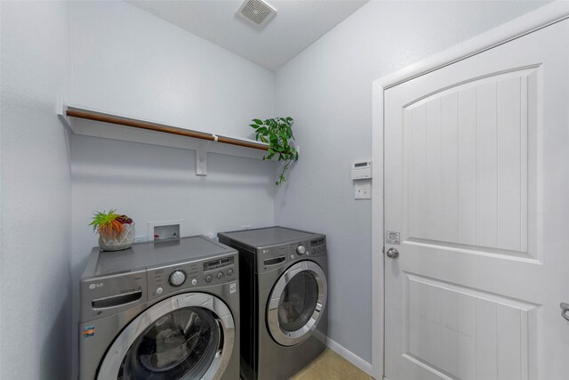 laundry area with baseboards, separate washer and dryer, laundry area, and visible vents