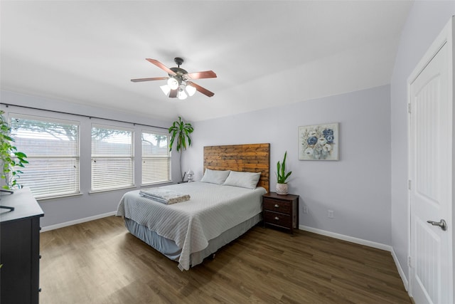 bedroom with baseboards, ceiling fan, and wood finished floors
