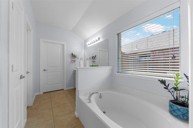 bathroom featuring a bath, tile patterned floors, and vaulted ceiling