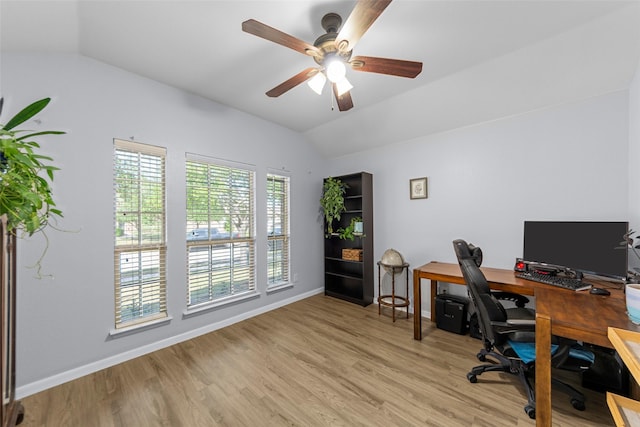 office with light wood-style floors, baseboards, vaulted ceiling, and a ceiling fan