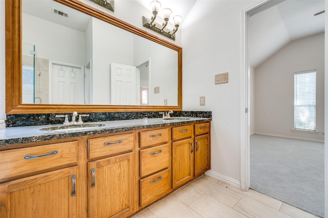 9133 Wichita Trl, Frisco, TX 75033 - full bathroom with a shower stall, vaulted ceiling, a sink, double vanity, and visible vents