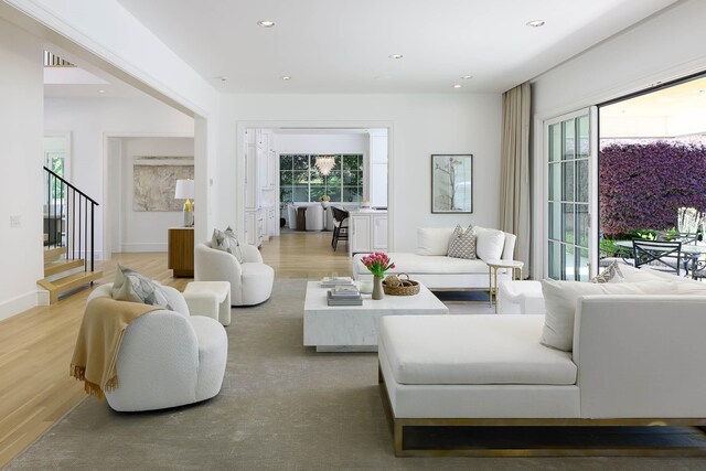 living area featuring recessed lighting, stairway, and light wood-type flooring