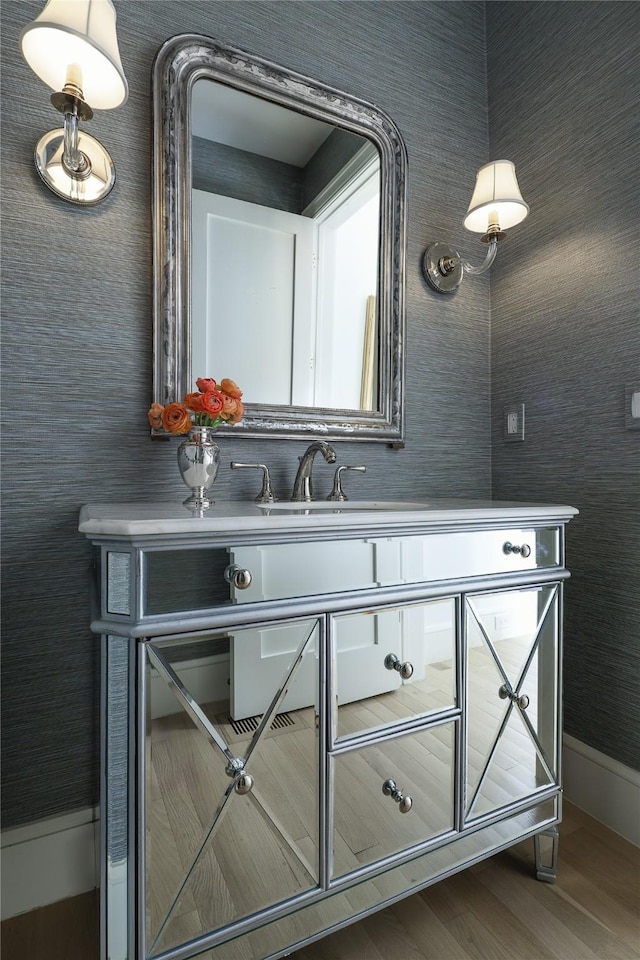 bar featuring a sink and wood finished floors