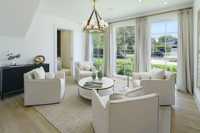 sitting room featuring recessed lighting, a notable chandelier, and light wood-style flooring