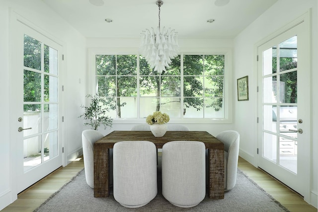 sunroom featuring an inviting chandelier and a wealth of natural light