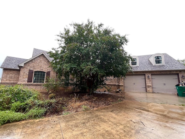 view of front of property with brick siding and a shingled roof