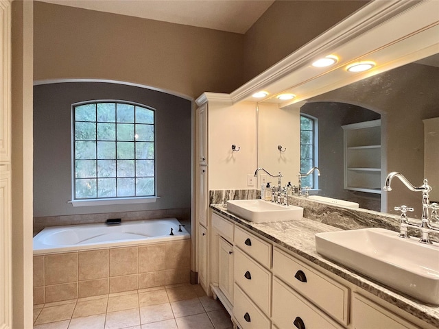 full bathroom featuring a sink, a wealth of natural light, and a bath