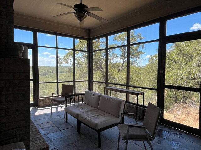sunroom / solarium featuring an outdoor living space and ceiling fan