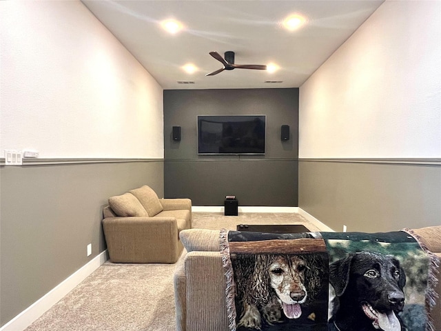 home theater room with visible vents, baseboards, a ceiling fan, and carpet